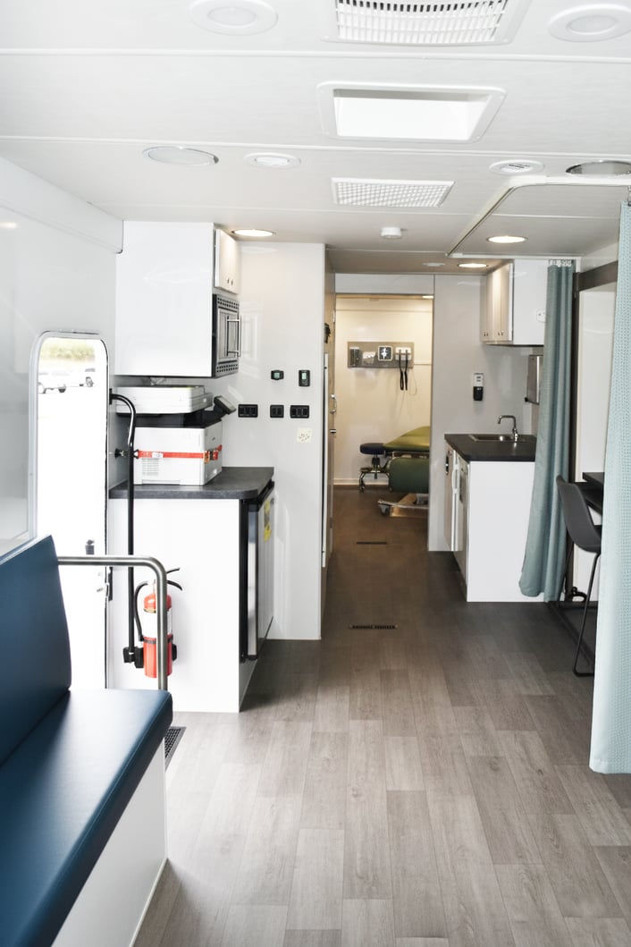 Patient-friendly interior of a mobile medical trailer with private consultation space and comfortable design