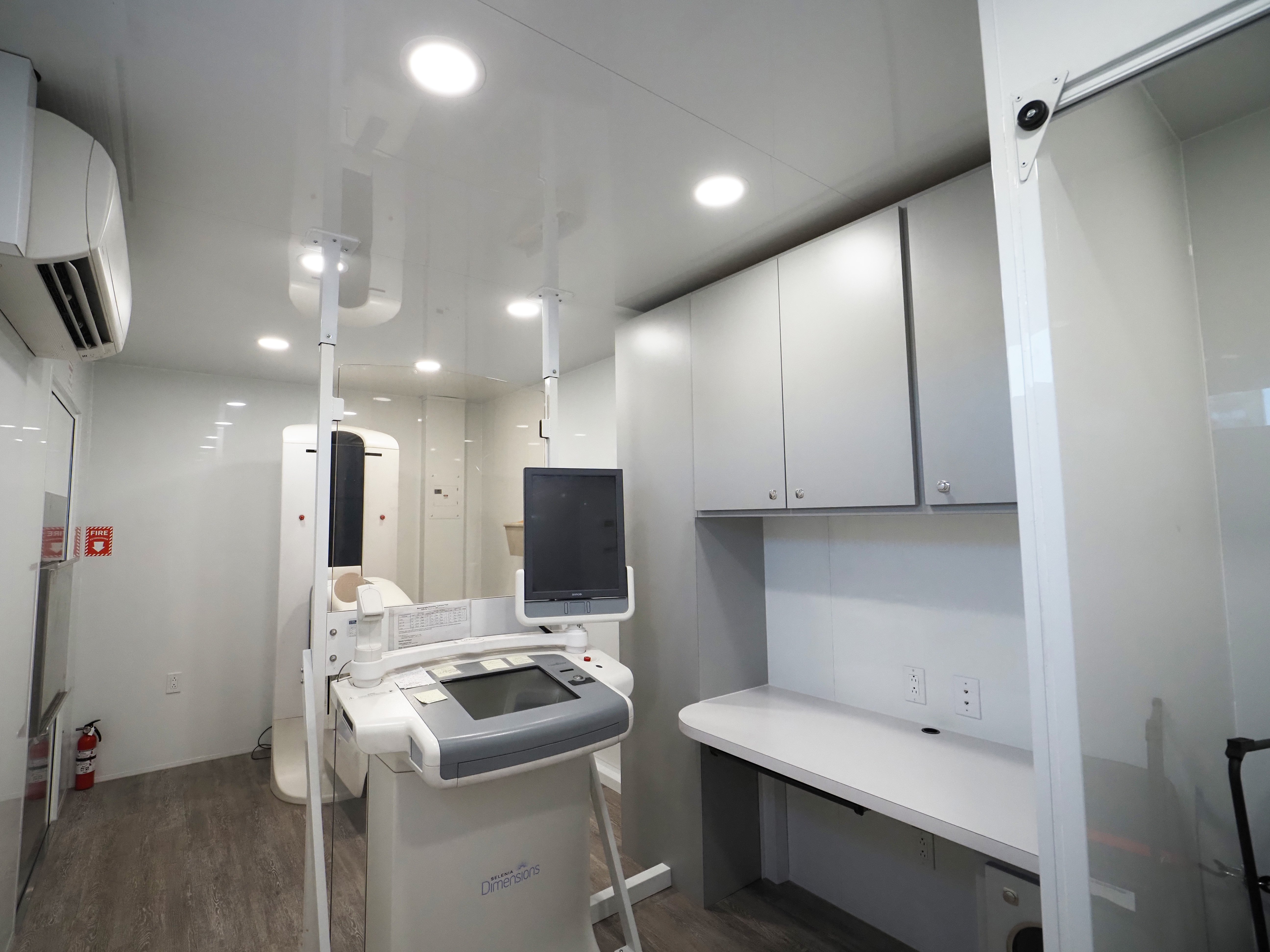 nterior of a medical trailer with patient exam rooms and clinical equipment.