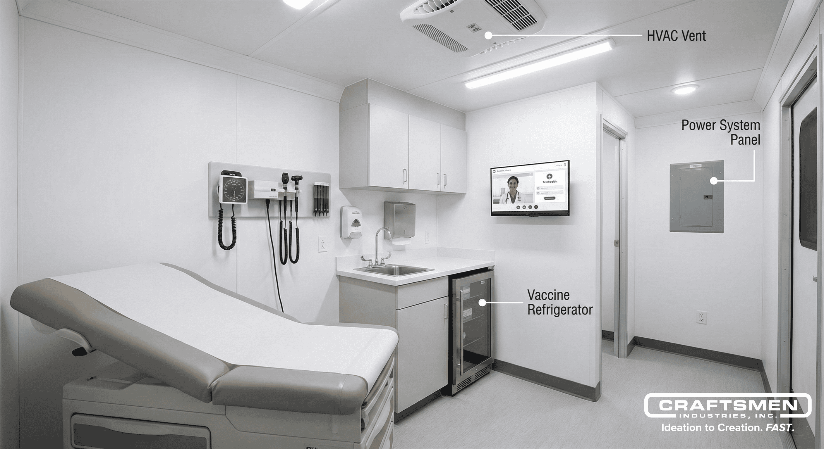 Interior of a mobile medical trailer with exam table and diagnostic equipment.