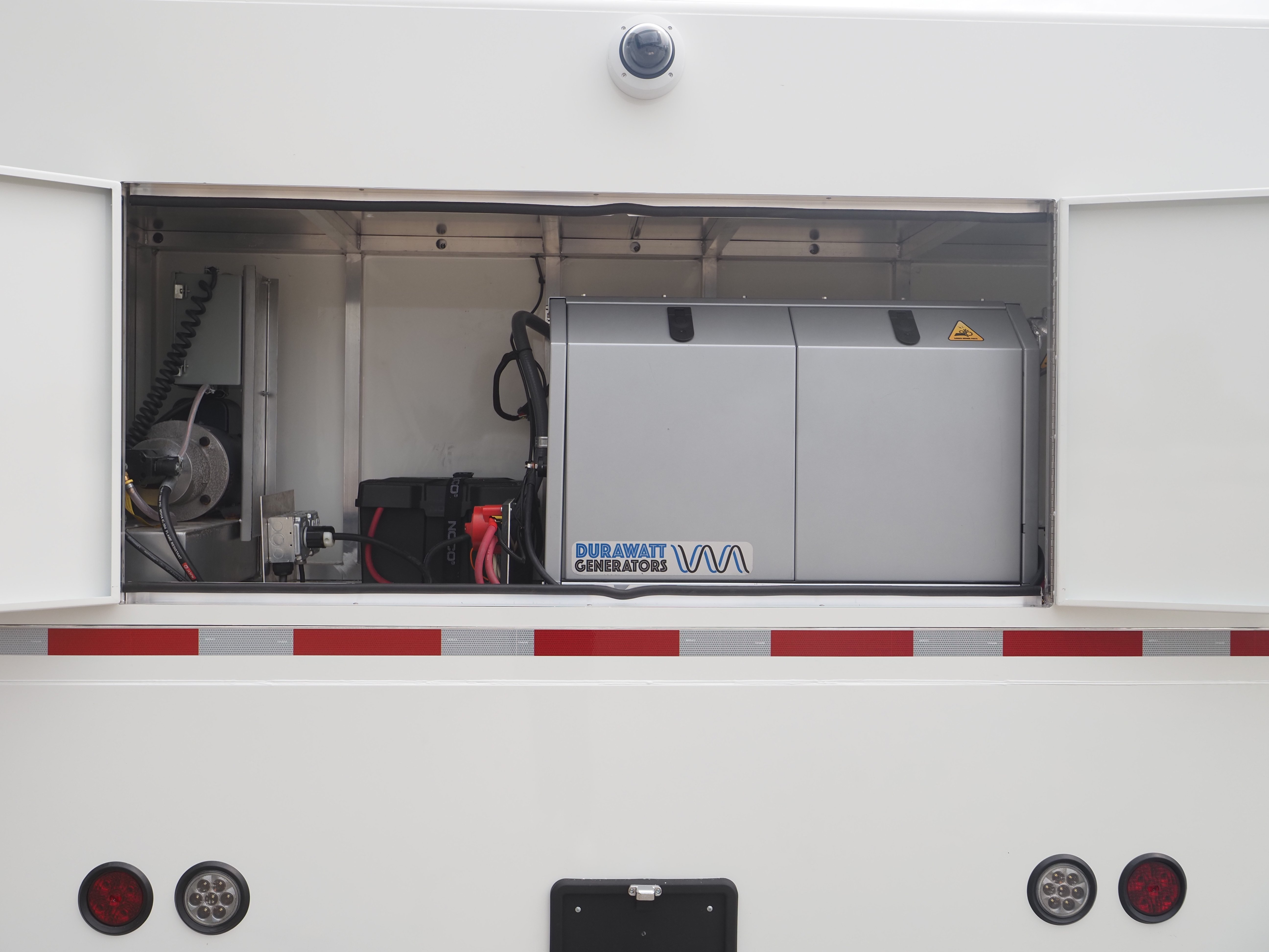 Self-sufficient medical trailer equipped with generators and solar panels for off-grid healthcare.