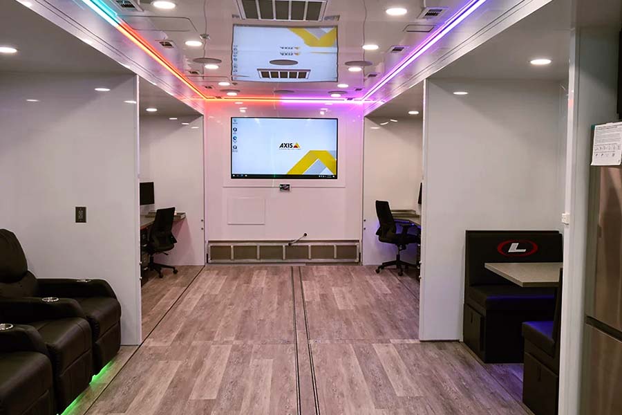 Ergonomic interior design of a mobile command center with Axis monitor, workstations, and ambient lighting