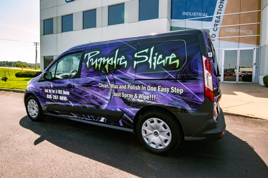 Small commercial van with a full-body custom vinyl wrap featuring a vibrant purple and black abstract graphic for "Purple Slice" cleaning product, emphasizing fleet graphic branding and mobile service advertising.