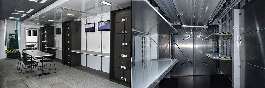 Split image of a mobile forensic lab or command center. (Left) Interior workspace with a white table, chairs, long desks, multiple monitors, and numbered black locker units. (Right) Close-up of a stainless steel decontamination or storage area with shelves and heavy-duty doors.