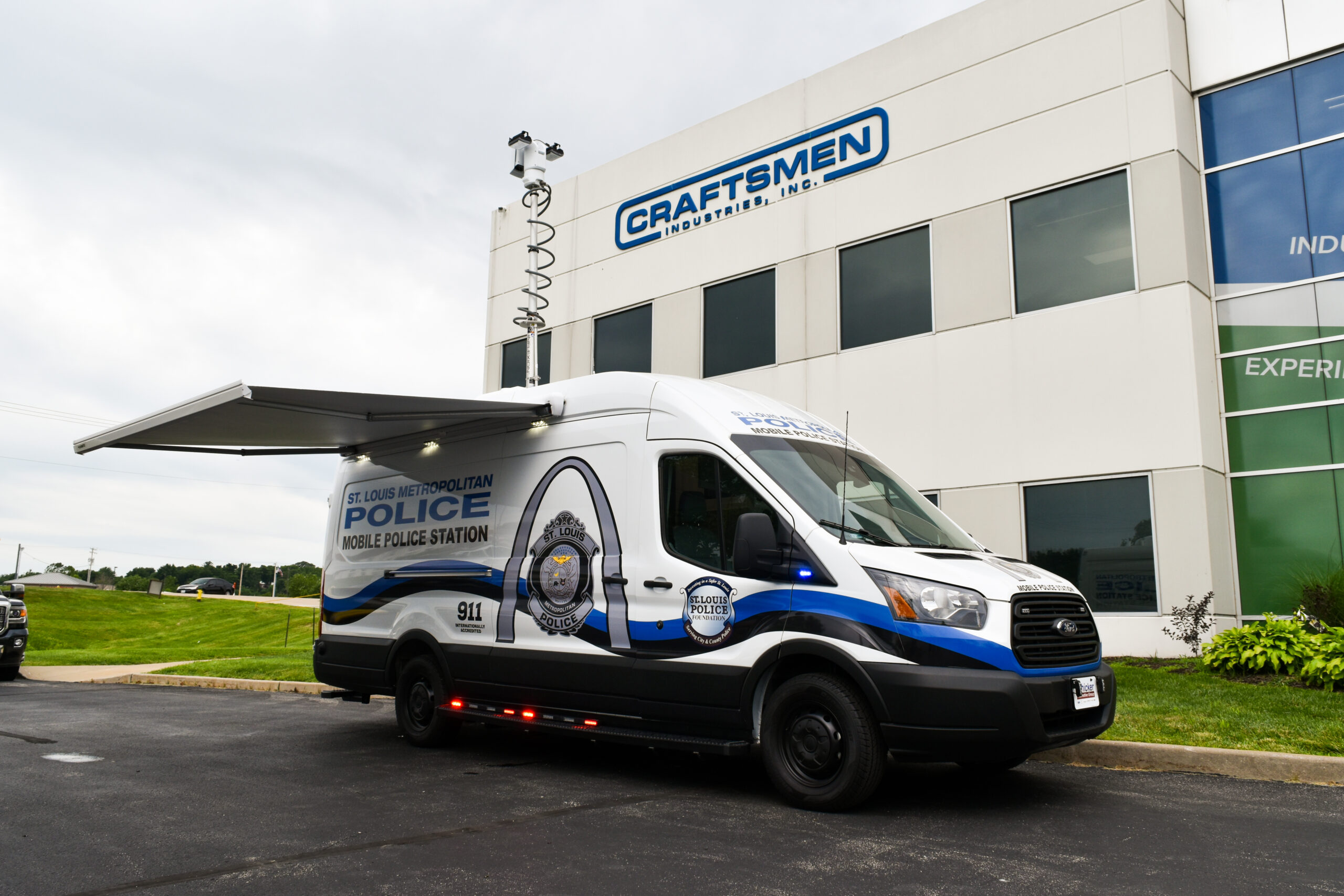 St. Louis Metropolitan Police mobile command station van, custom-built by Craftsmen Industries, parked in front of the Craftsmen Industries building.