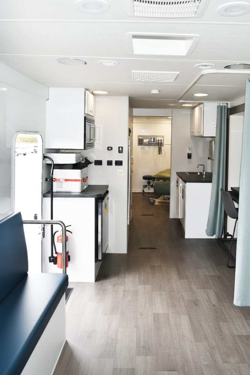 Patient-friendly interior of a mobile medical trailer with private consultation space and comfortable design