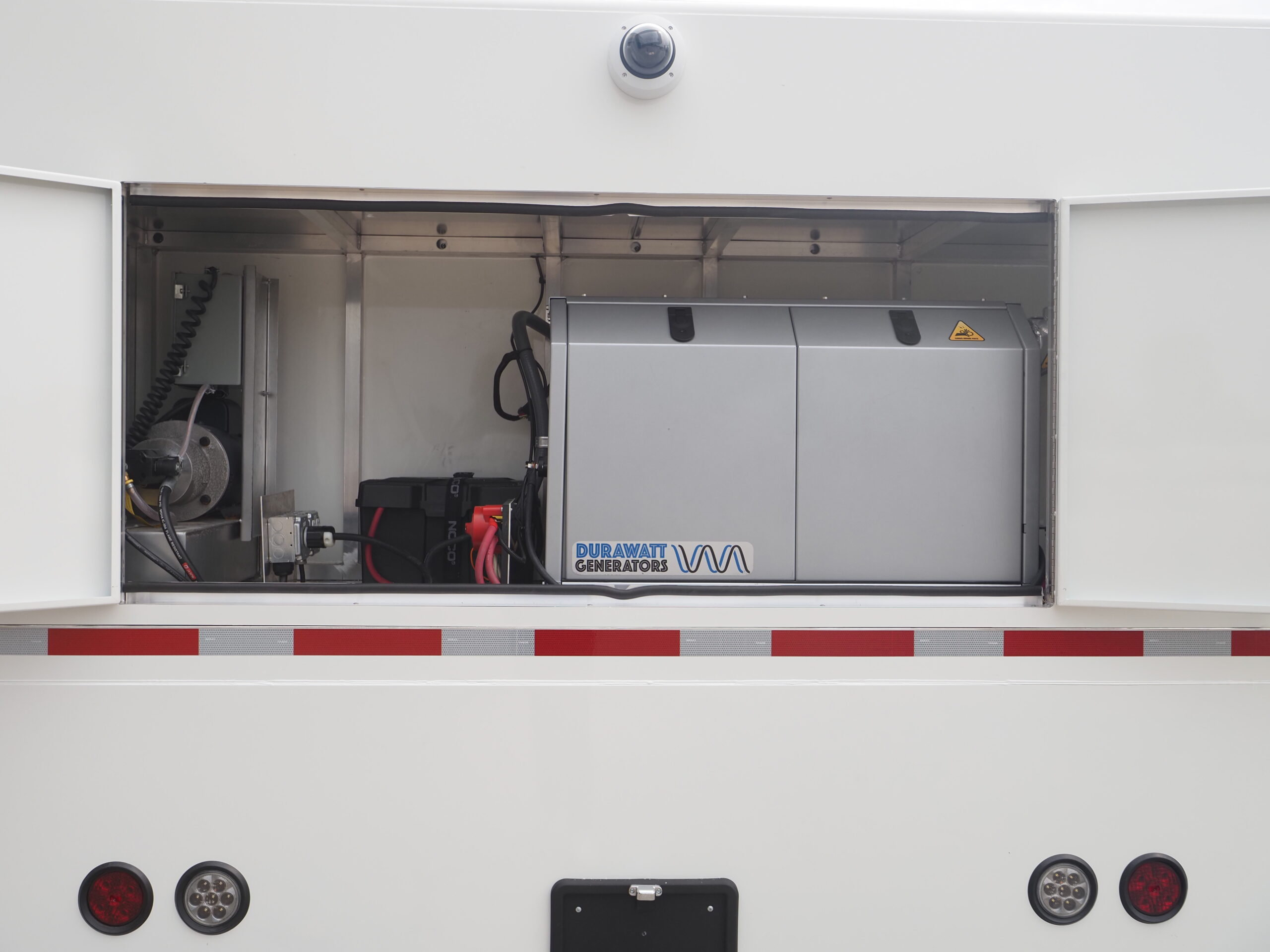 Self-sufficient medical trailer equipped with generators and solar panels for off-grid healthcare.