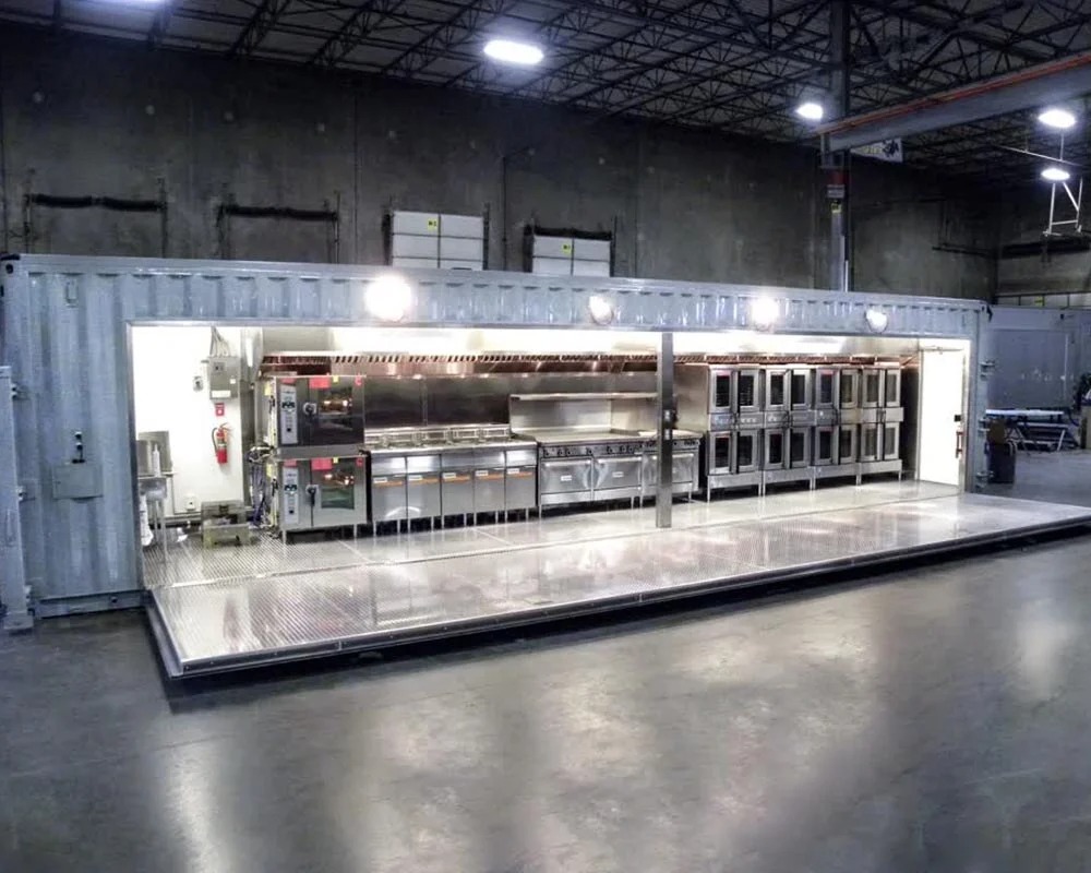 Interior view of a fully-equipped, stainless steel Americrown shipping container restaurant or commercial kitchen conversion.-1