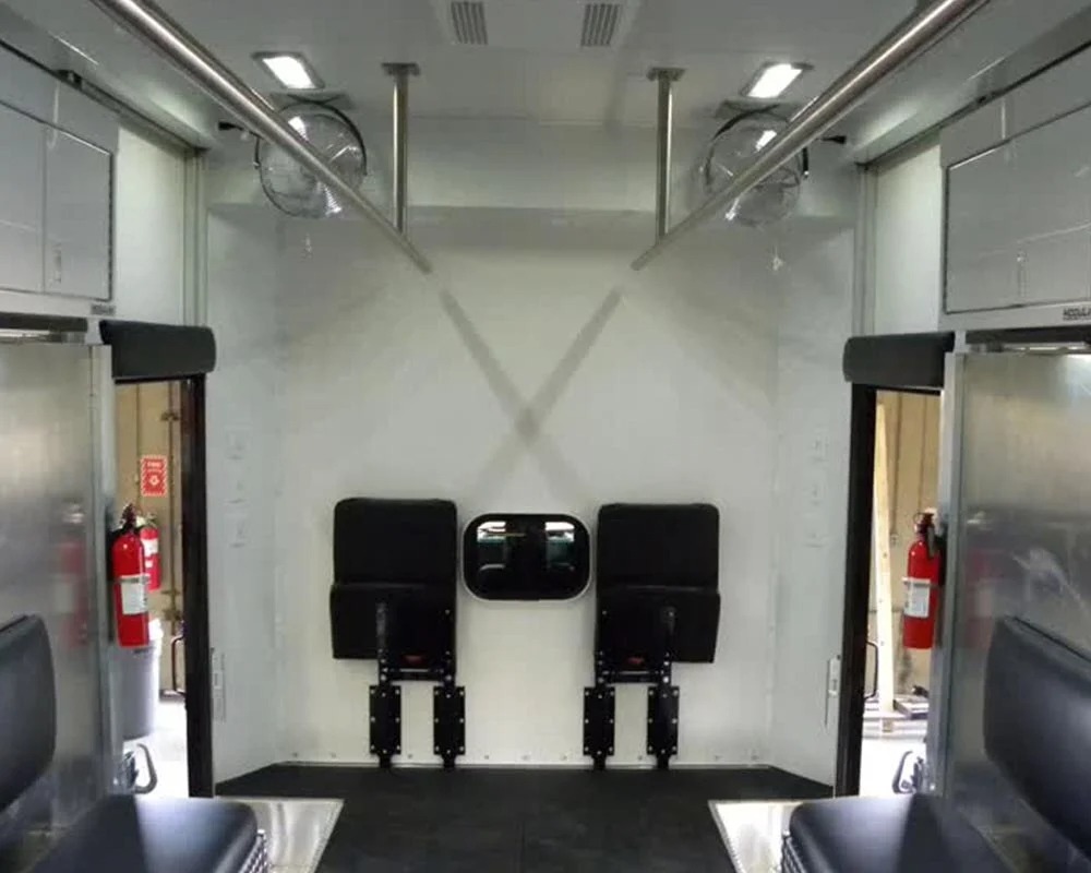Customized SWAT truck interior with benches, cabinets, and tactical chairs