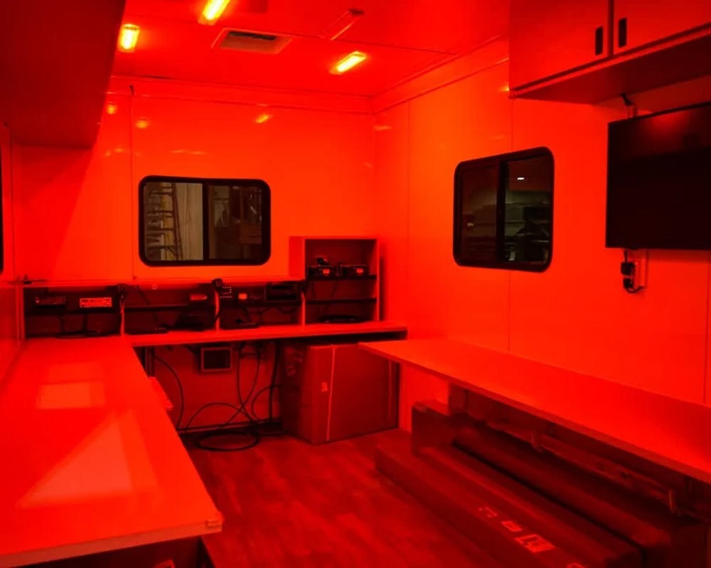 SATERN mobile communications trailer with red lights and electronic equipment