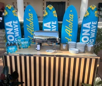 Kona Big Wave Super Bowl bar with bright blue surfboard graphics and beer display.