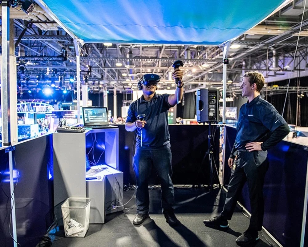 Visitor experiencing virtual reality training using a VR headset at a mobile event booth.