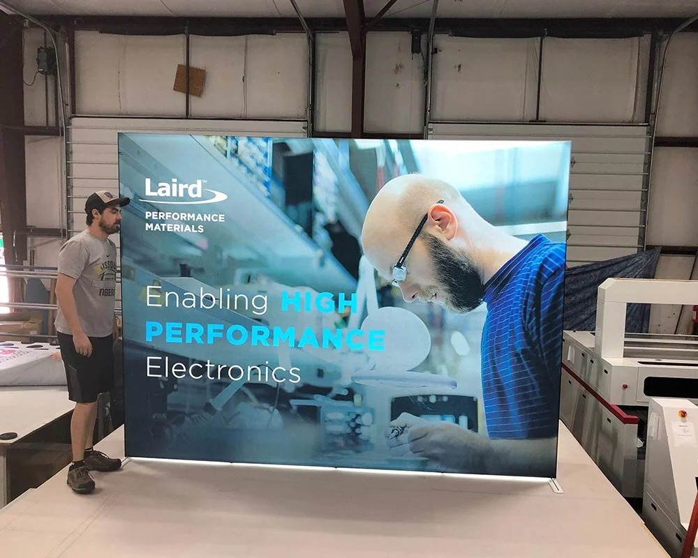 Large backlit SEG fabric display graphic for Laird Performance Materials showcasing