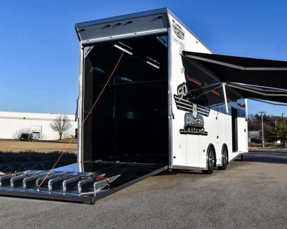 Epic Wallace Southern Country Customs race car trailer exterior with rear ramp door open and side awning extended