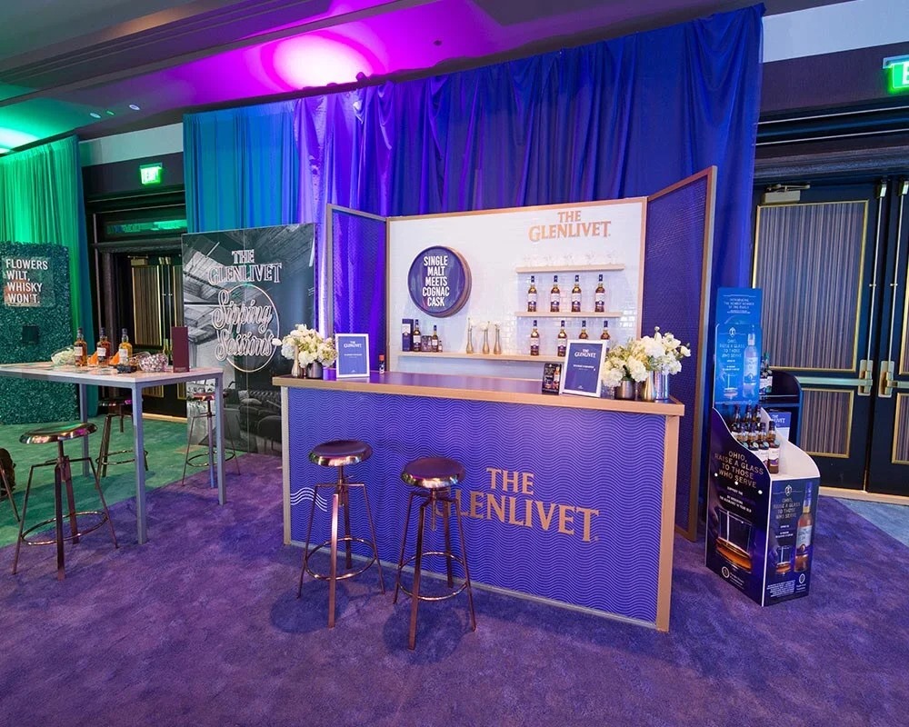 The Glenlivet branded event bar display with purple counter, Cognac Cask theme, and gold accents.