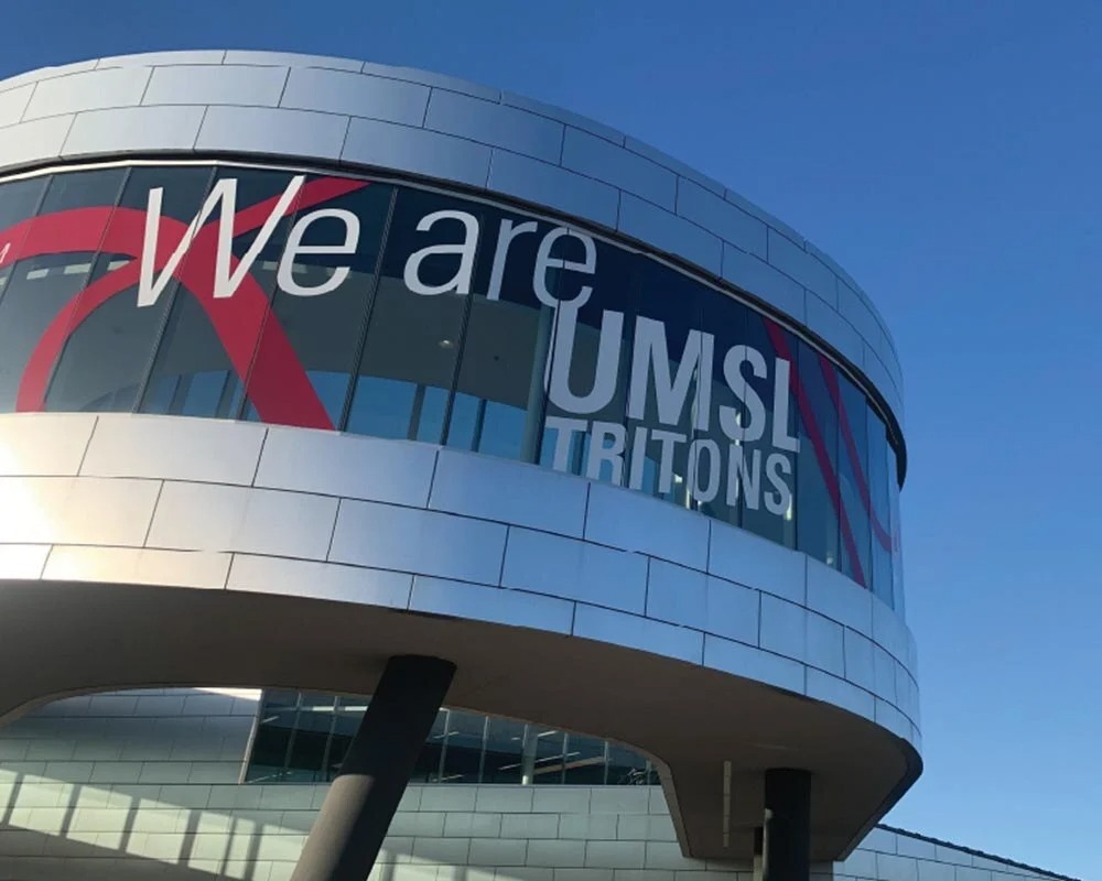 Custom vinyl window graphic installation on UMSL Recreation and Wellness Center curved facade displaying