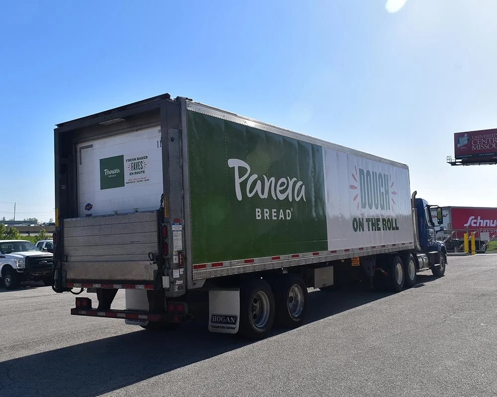 Panera Bread delivery truck trailer with a green wrap promoting