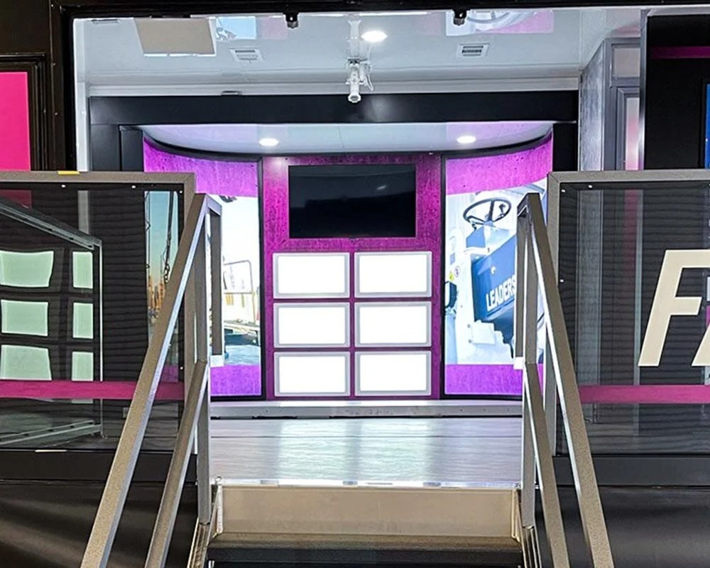 Modern, well-designed interior of a mobile dental clinic with medical staff in the hallway.