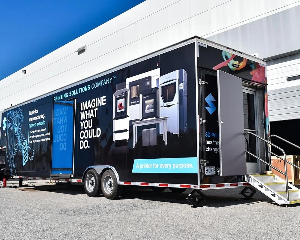 Stratasys branded mobile exhibit showcasing 3D printing technology and innovative additive manufacturing solutions in a modern display trailer