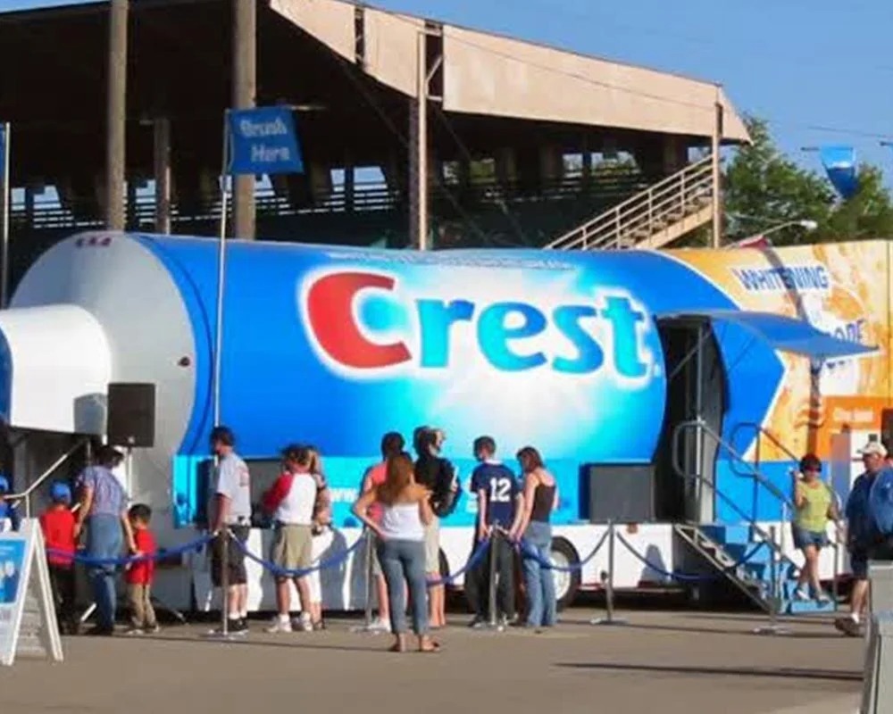 Giant Crest toothpaste tube trailer with an entrance for a mobile experiential event and interactive dental display.