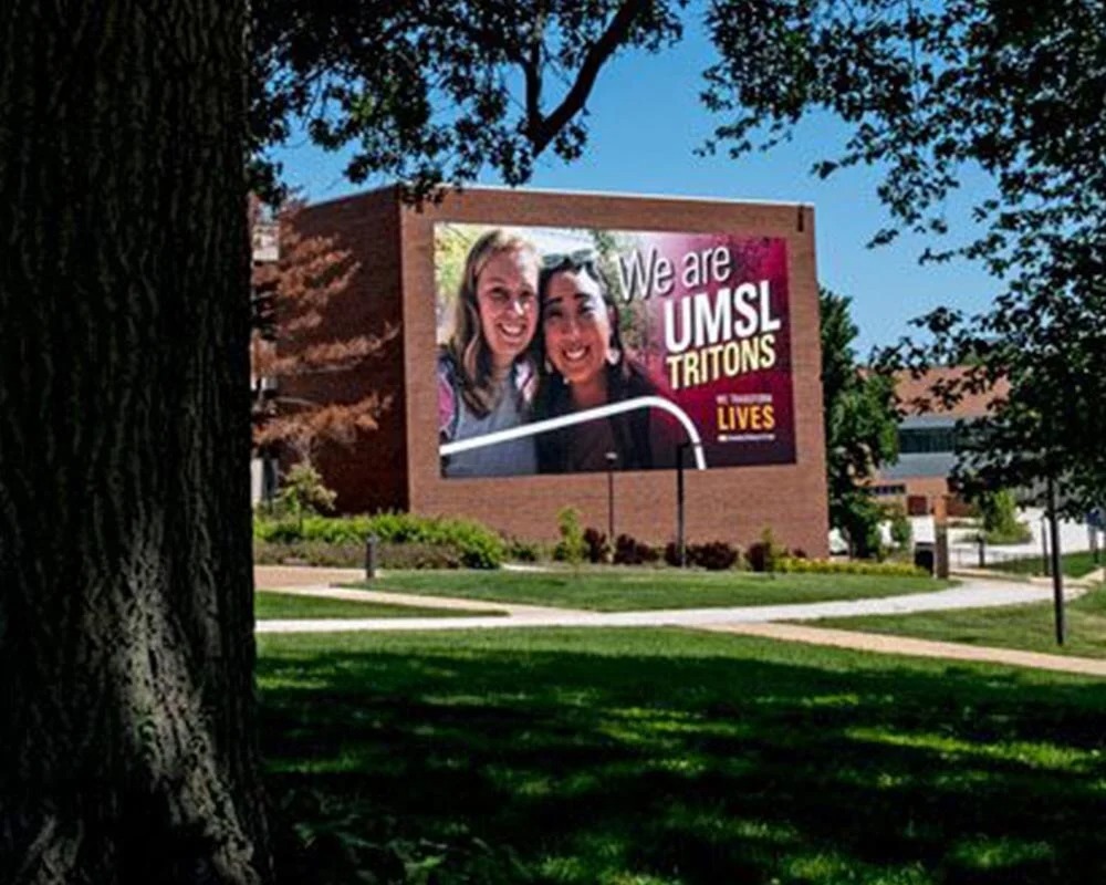University of Missouri-St. Louis (UMSL) campus building wrap featuring two female students