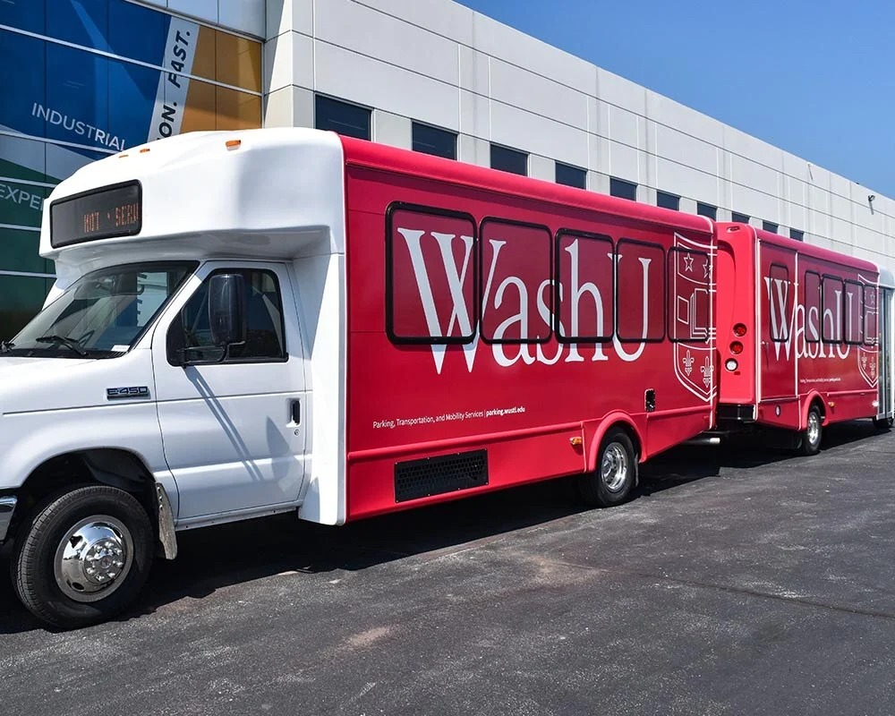 Custom red vinyl wrap on WashU shuttle bus