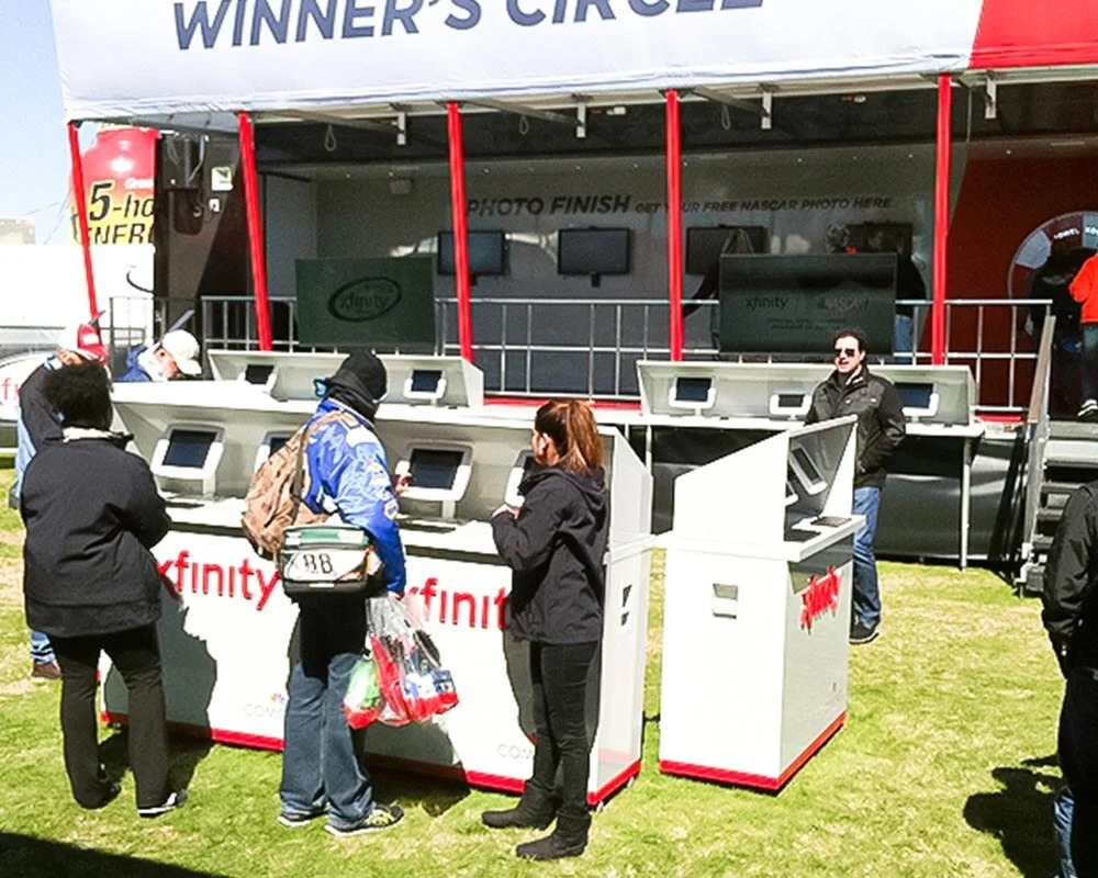 Xfinity mobile marketing trailer and interactive kiosks set up for the NASCAR Winner's Circle event.