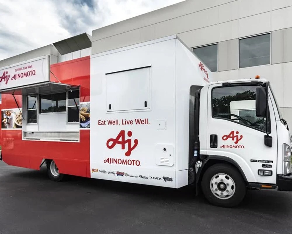 Ajinomoto custom food truck, painted red and white with branding, built by food truck builders for corporate promotion.