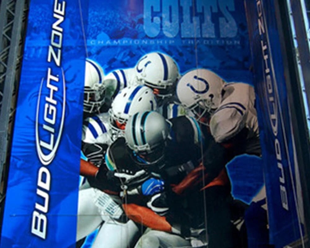 Giant Bud Light Party Zone stadium mural graphic featuring Indianapolis Colts fans cheering behind football helmets.