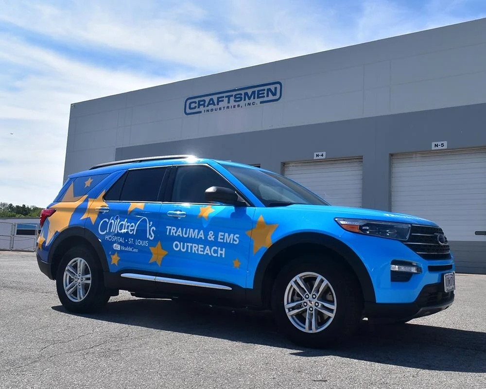 Blue Children's Hospital St. Louis Trauma & EMS Outreach truck with yellow stars and white logo wrap.