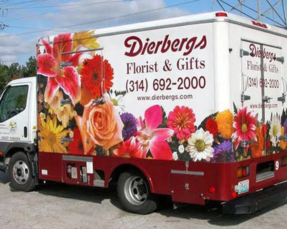 Dierbergs Florist & Gifts mobile billboard truck with a full wrap of colorful roses, lilies, and other fresh flowers.