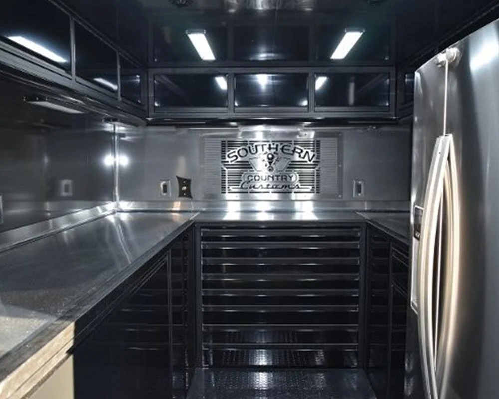Epic Wallace Southern Country Customs race car trailer interior showing tool storage stainless steel workbench and refrigerator