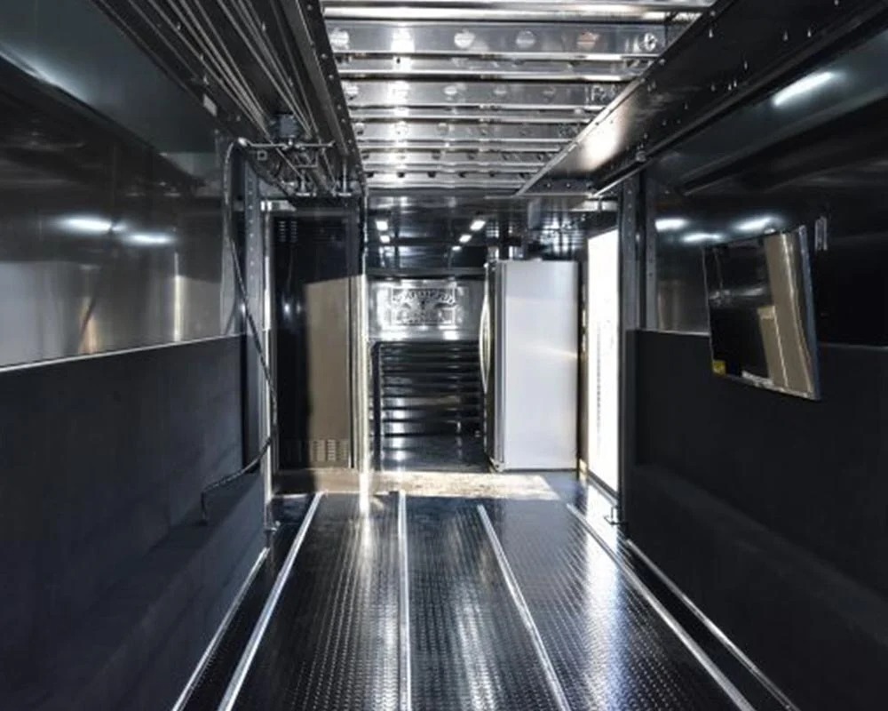 Epic Wallace Southern Country Customs race car trailer interior view of the vehicle loading area with diamond plate floor and shiny black walls