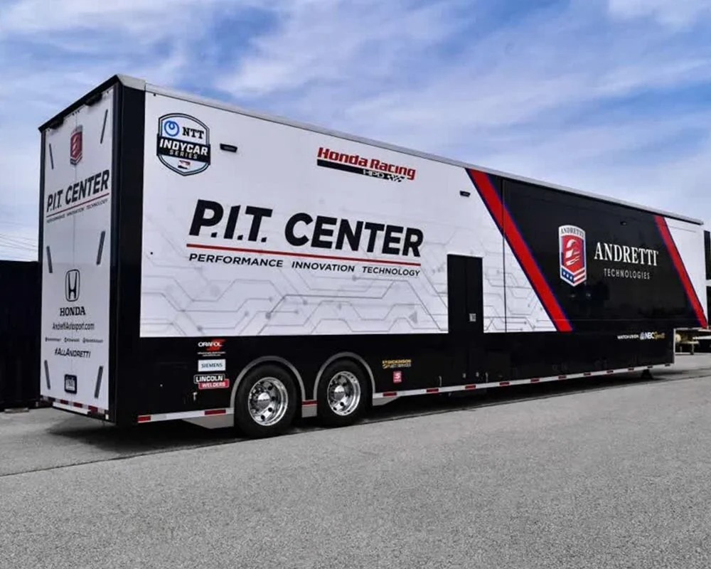 Honda Racing Andretti Technologies NTT IndyCar Series race car hauler trailer featuring PIT Center logo and sponsorship branding