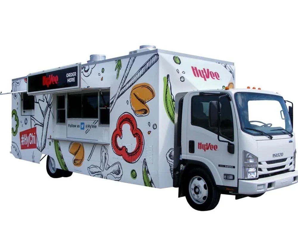 Hy-Vee Asian cuisine food truck, called #HyChi, with custom white and illustrated vegetable graphics, built by food truck builders.
