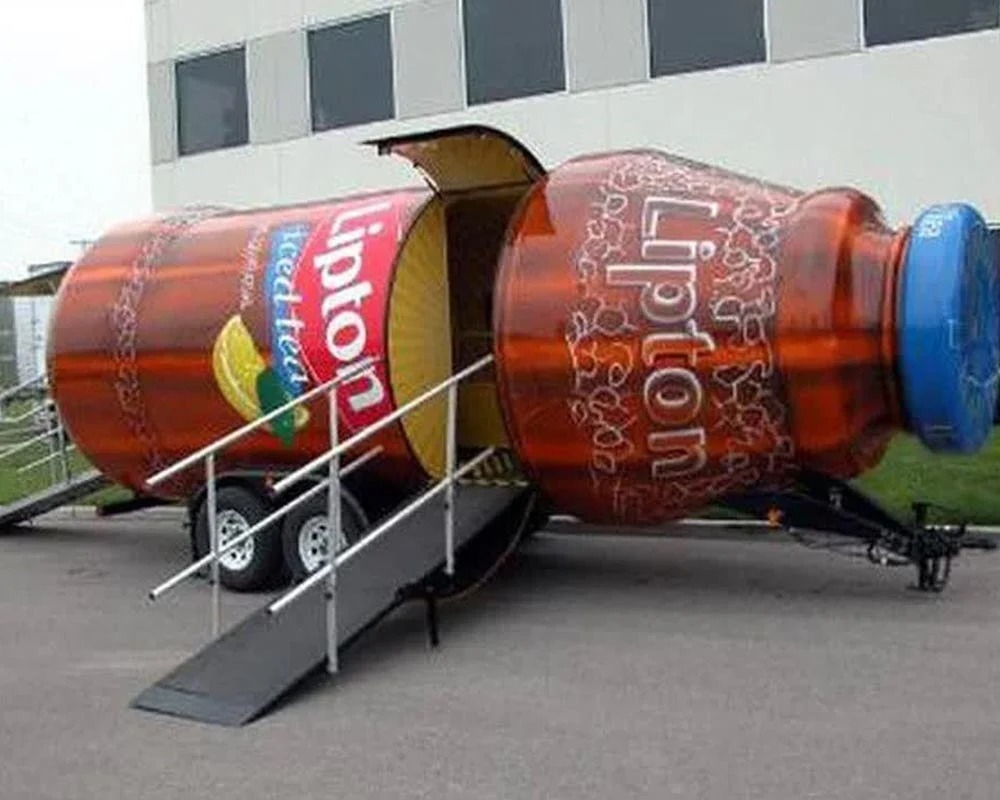 Lipton Iced Tea bottle-shaped promotional trailer with open entrance ramp used for brand activation and outdoor marketing events.