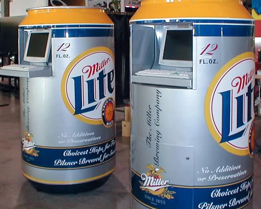 Two giant Miller Lite beer cans converted into interactive computer kiosks for an experiential event.