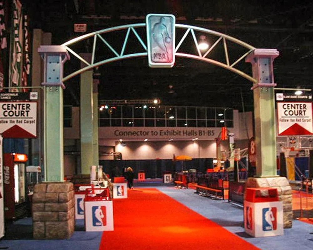 NBA Center Court entrance archway with logo over a red carpet at an indoor experiential event.