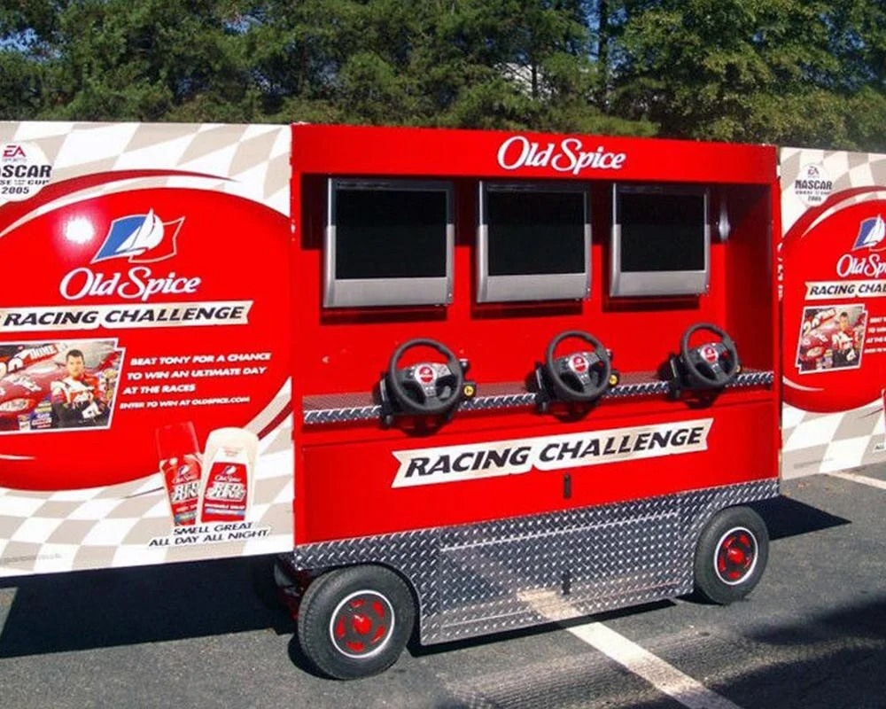 Old Spice Racing Challenge mobile arcade with three steering wheels and screens for a NASCAR experiential event.