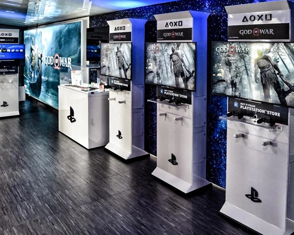 PlayStation mobile experience center interior with multiple God of War gaming demo kiosks.