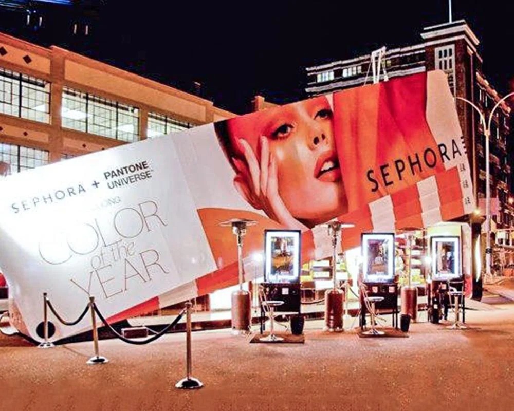 Sephora and Pantone Color of the Year shipping container conversion into a massive cosmetics display, lit up at night for experiential marketing.