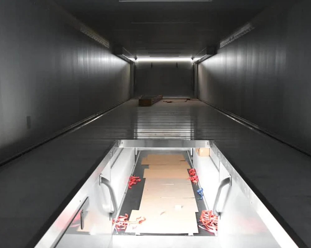 Stock race car trailer upper deck or loft storage area with floor hatch open and empty vehicle bay