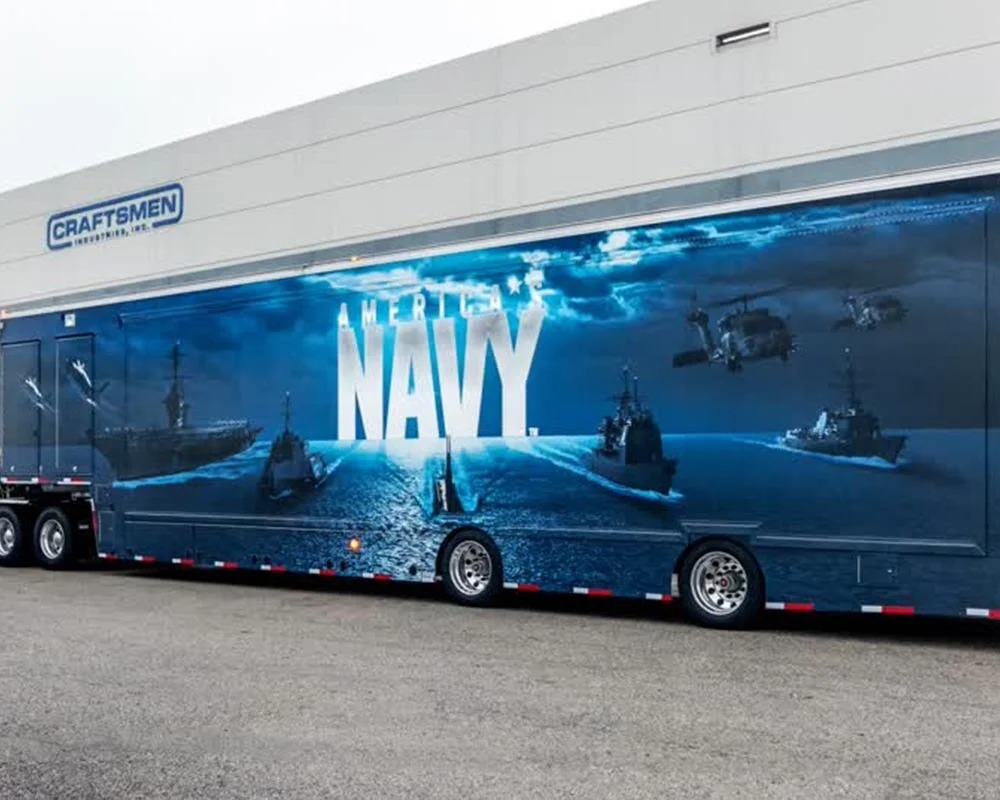 U.S. Navy recruitment mobile billboard trailer with a large wrap of warships, helicopters, and the