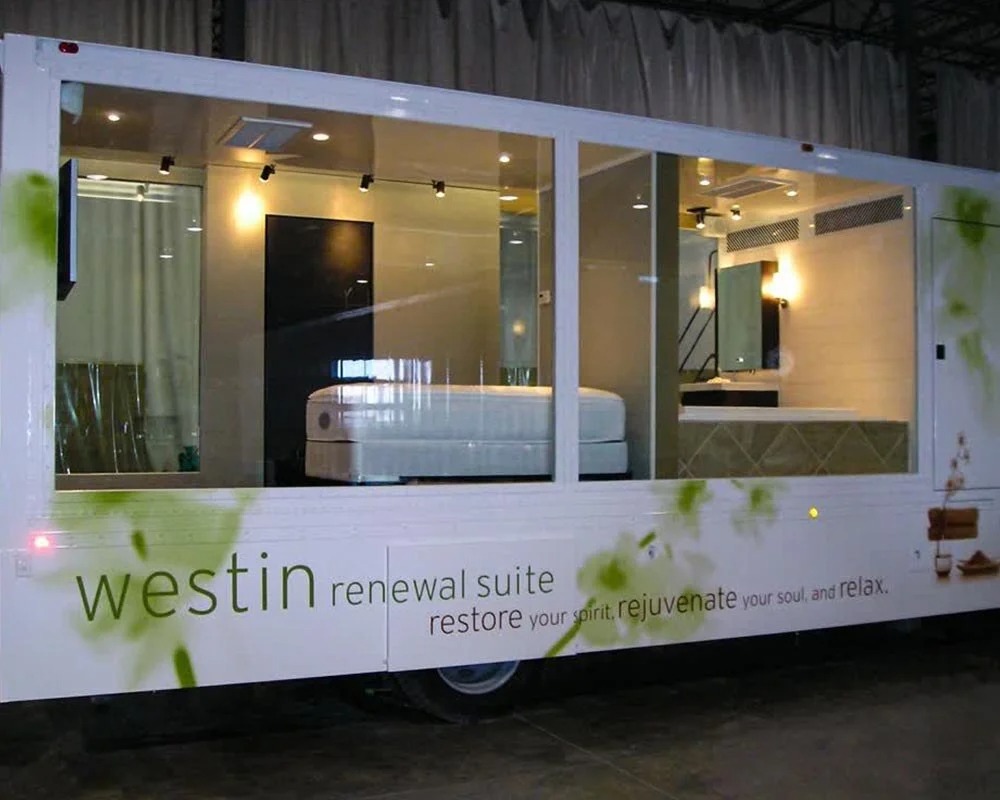 Westin Renewal Suite mobile showroom trailer with large windows showcasing the Heavenly Bed and spa bathroom concept.