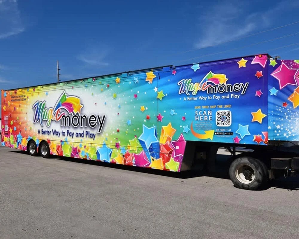 Magic Money fleet trailer with colorful branded graphics and a scannable QR code demonstrating interactive mobile advertising.