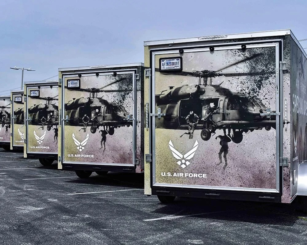 U.S. Air Force fleet trailers featuring custom military vehicle graphics with helicopters, service members, and Air Force branding.