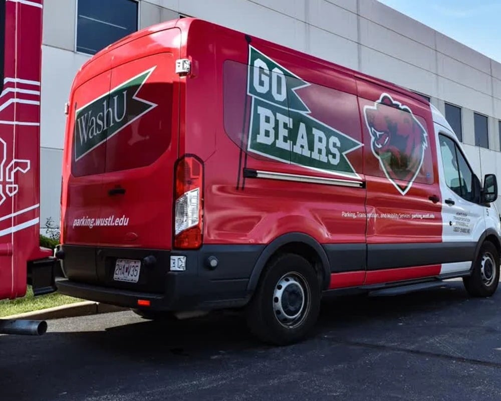 WashU-branded fleet van with bold red vehicle graphics, illustrating how last-mile delivery vans can maximize residential brand exposure.